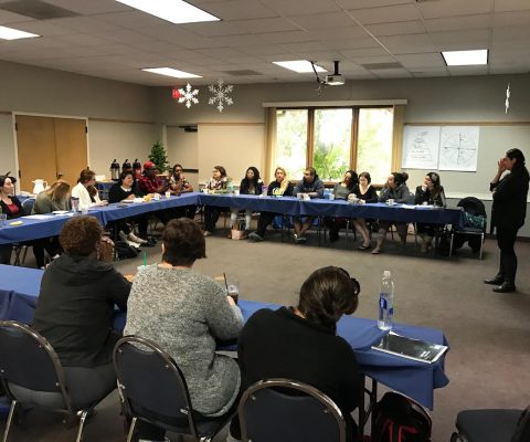 a group of people sitting at tables in a room