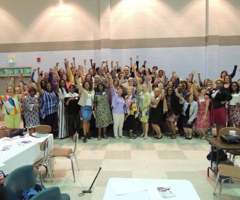 a large group of people standing in a room